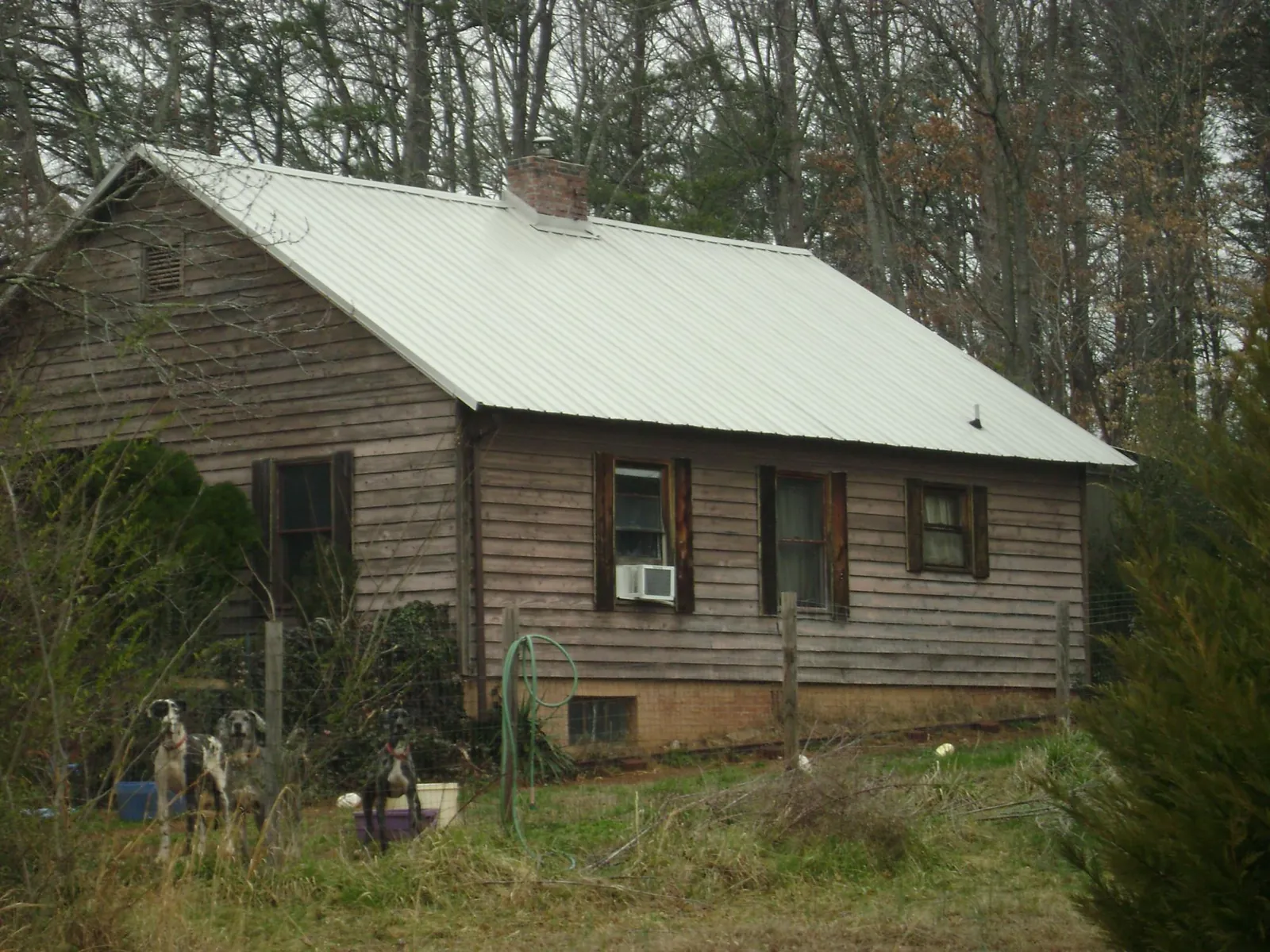 White metal roof on an old wood sided farmhouse, from a Metal Roof Installation job in Halifax
